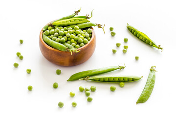 Bowl of green pea pod with beans on kitchen desk. Close up
