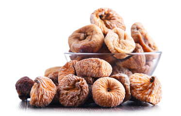 Composition with bowl of dried figs isolated on white