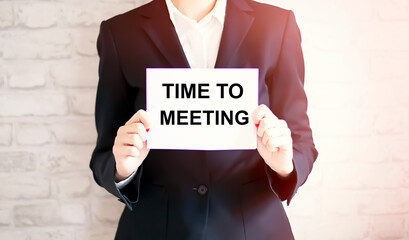 woman showing white card with TIME TO MEETING word . Business