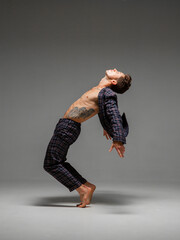 Cool young stylish guy dancer in suit dancing hip-hop. Dance school poster. Dance lessons