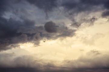 Beautiful evening cloudy sky. Gray sky with warm light