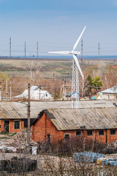 Wind turbine in the industrial area of the village. The picture was taken in Russia, in the Orenburg region, in the countryside