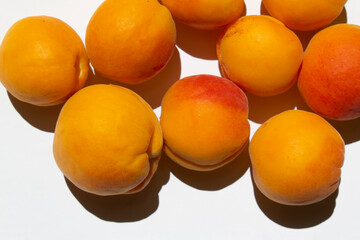 yellow ripe summer apricots fruits on a white background vegan food organic store market concept 