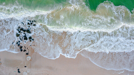 Aerial panoramic drone view of beautiful ocean waves and sand beach