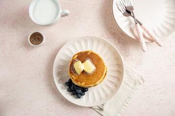 cup of coffee and pancake with butter and berry