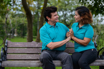 Happy mature multi ethnic married couple together and in love at the park