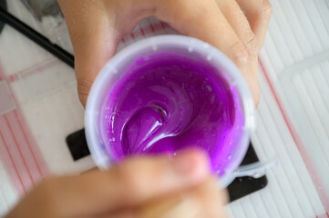 Little girl makes a homemade slime. Selective focus.