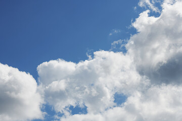 Naklejka na ściany i meble Pre-storm cumulus clouds against blue sky