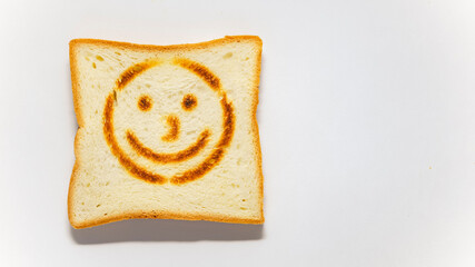 White bread toast with smile on white background