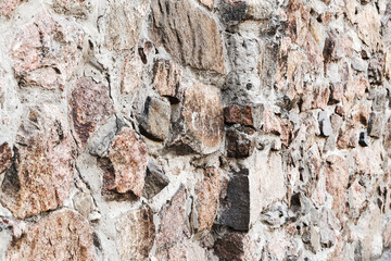 Abstract background of the old wall of black natural stone with cracks and scratches. Landscape style. Great background or texture.