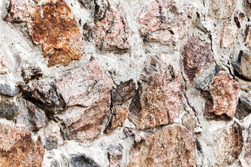 Abstract background of the old wall of black natural stone with cracks and scratches. Landscape style. Great background or texture.
