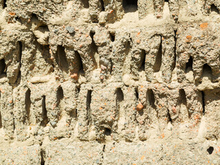 Abstract background of the old wall of black natural stone with cracks and scratches. Landscape...