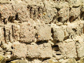 Abstract background of the old wall of black natural stone with cracks and scratches. Landscape style. Great background or texture.