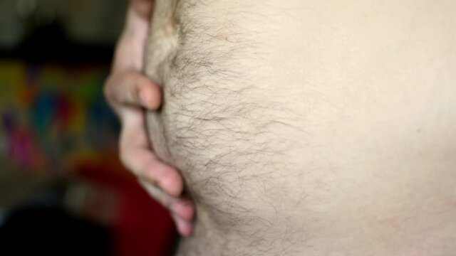 Fat belly of a man.The harm of overeating. Wrong food. Obesity.