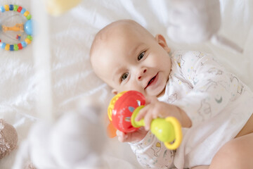 Happy baby playing in crib