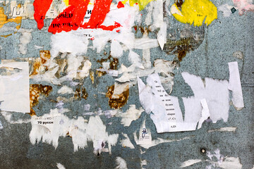Urban Billboard With Torn Peeled Poster Horizontal Wide Grungy Background. Outdoor Bulletin Board Or Plywood Panel With Worn Advertising Message Notice And Stickers Street Texture. Abstract Web Banner