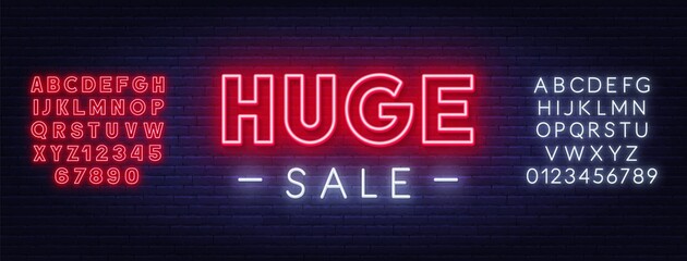 Huge Sale neon sign on brick wall background. Red and white neon alphabets.