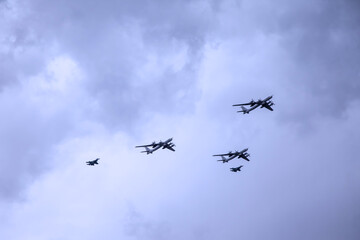 Fototapeta na wymiar Military aircraft of Russian armed forces fly in sky with texture clouds. Plane is flying. Naval parade. Day of Navy Russia. Naval parade. Holidays of Saint Petersburg, Russia. Rehearsal of parade