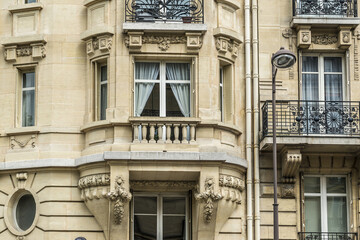 Old French house with traditional balconies and windows. Paris, France.
