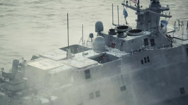 Drone shot of navy ship on foggy sea, top