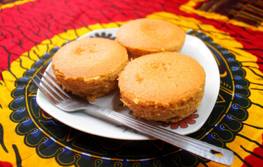 A Delicious Meal of Bean Cakes or Nigerian Moi Moi served in a white plate and placed on a colorful...