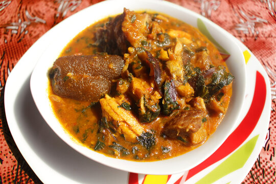 Close up of a bowl of ogbono soup. This is a popular Nigerian dish usually served with other foods to swallow. It contains beef, dried fish, chopped meat pieces, kpomo and little vegetable