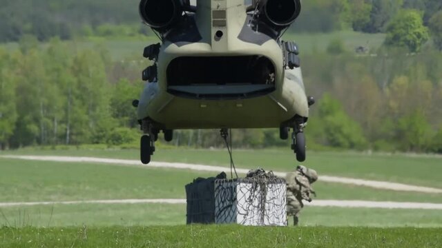 Helicopter preparing to lift supply boxes