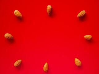 Almonds isolated red background