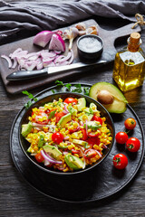 sweet corn salad with avocado in a bowl