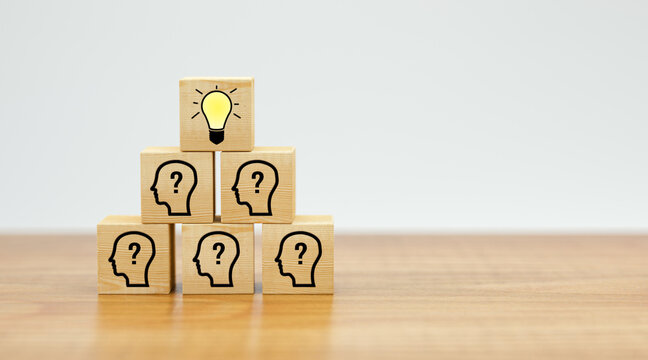 cubes showing a brainstorming session on wooden surface and white background