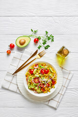sweet corn salad with avocado in a bowl