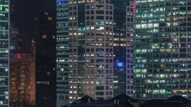 Aerial cityscape of Singapore downtown of modern architecture with illuminated skyscrapers night timelapse, view from above in chinatown district with glowing windows in towers