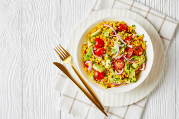 sweet corn salad with avocado in a bowl