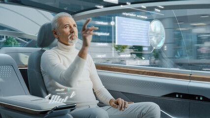 Attractive Senior Man Using Futuristic Augmented Reality Interface for Reading News and Checking...