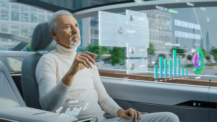 Attractive Senior Man Using Futuristic Augmented Reality Interface for Reading News and Checking...