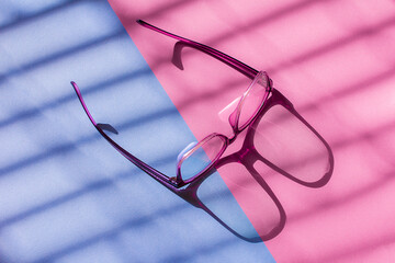 Purple glasses on two color background.