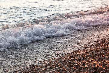 sea wave at sunset, pebble beach on the Croatian coast