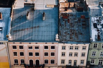 View from above of the dark blue tiled roofs with attic windows. The photo was taken from the tower of the town hall in the center of Lviv, in Ukraine.