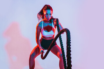 Fit woman training hardwith ropes