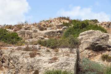 The letters  A and T in the old Phoenician language are carved on the stone wall of the old Phoenician fortress, which later became the Roman city of Karta, near the city of Atlit in northern Israel