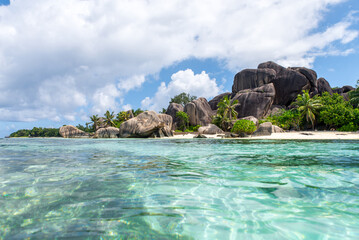 Beautiful island in the seychelles. La digue, anse d'argent beach. Water flowing, and waves foam on a tropical landscape