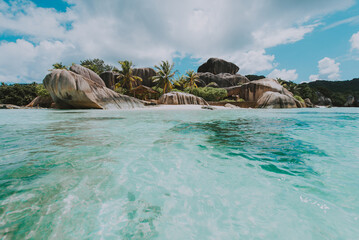 Beautiful island in the seychelles. La digue, anse d'argent beach. Water flowing, and waves foam on a tropical landscape