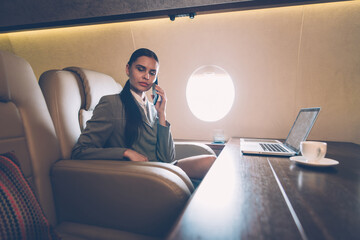 Business woman traveling and working on the private jet