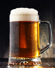 Composition with glass of beer on wooden background