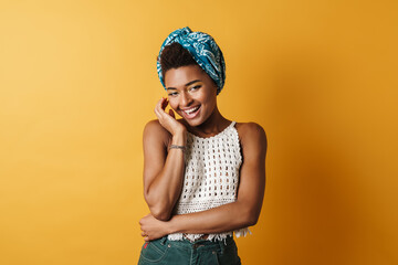 Image of joyful african american woman posing and laughing on camera