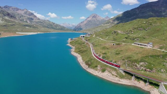 Aerial 4K - Switzerland, Bernina Pass, view of the train and the Bianco lake