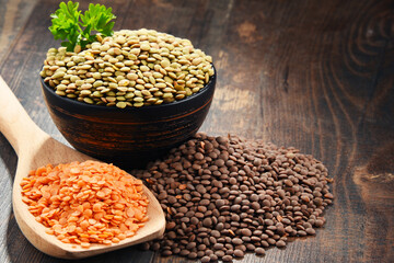 Composition with bowl of lentils on wooden table