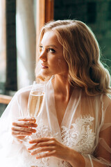 Portrait of a luxurious blonde with a glass of champagne in hand