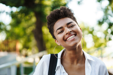 African woman walking outdoors in park