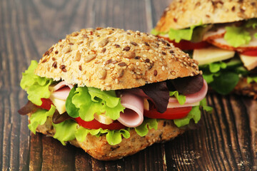 Two sandwiches with whole grain bread, ham and vegetables	